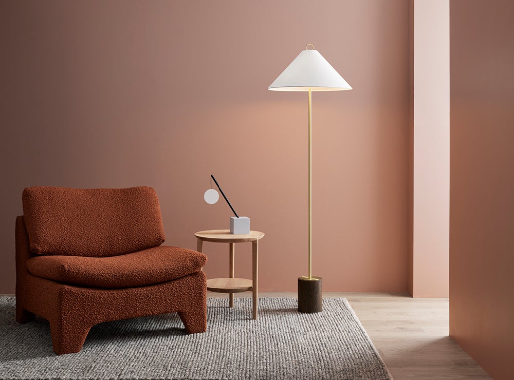 Floor lamp styled next to an armchair and side table